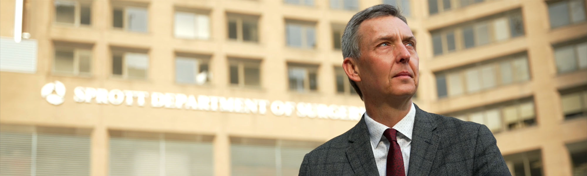 Dr. Tom Forbes in front of TGH Sprott Department of Surgery