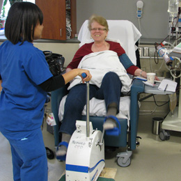  Physiotherapist assisting patient with bicycle exercise